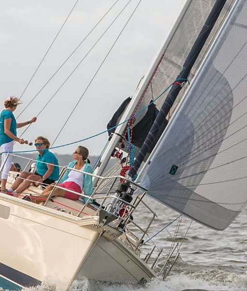 A sailing yacht under sail with her crew on the rail