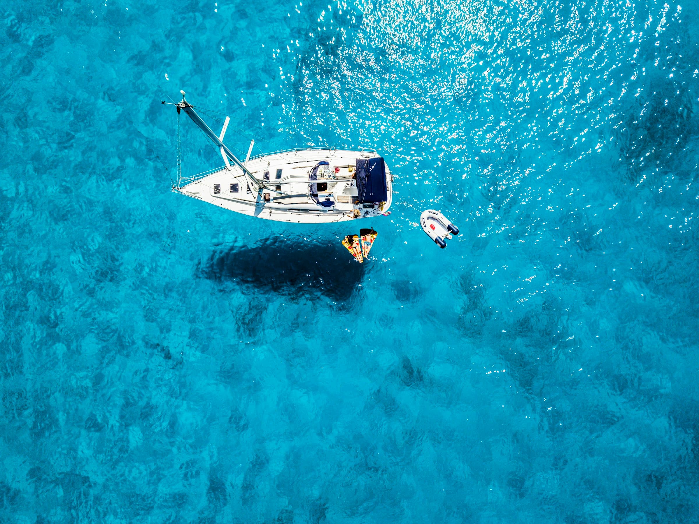 A classic cruising yacht under power on a calm bay