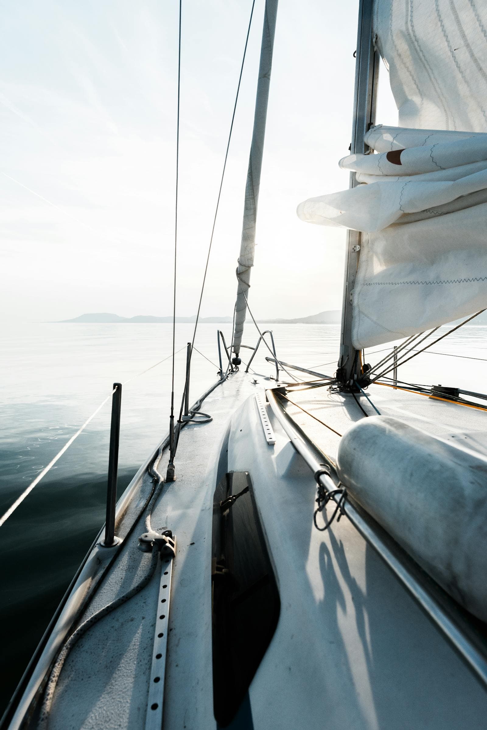 A cruising yacht at sea under sail at golden hour